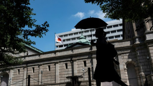 Markets sink, dollar gains as Fed hints at fresh rate hike