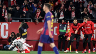 Barca suffer title defence blow in Girona derby defeat